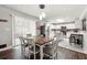 Bright dining area connecting the living room and featuring hardwood floors and white cabinets with stainless steel appliances at 3457 Scenic Dr, East Point, GA 30344