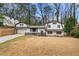 Charming home featuring a unique architectural style, complemented by a spacious front yard and mature trees at 3457 Scenic Dr, East Point, GA 30344