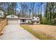 Charming home featuring a unique architectural style, complemented by a spacious front yard and mature trees at 3457 Scenic Dr, East Point, GA 30344