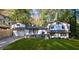 Charming home featuring a unique architectural style, complemented by a well-manicured front yard and mature trees at 3457 Scenic Dr, East Point, GA 30344