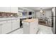 Bright kitchen with white cabinetry, marble floors, and butcher block island at 3457 Scenic Dr, East Point, GA 30344