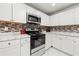 Bright kitchen with white cabinets, stainless steel appliances, and modern backsplash at 3457 Scenic Dr, East Point, GA 30344