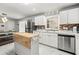 Modern kitchen with stainless steel appliances, white cabinets, and butcher block island at 3457 Scenic Dr, East Point, GA 30344