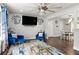 Open-concept living room features hardwood floors, and stylish blue furniture and flows into a dining area with ample seating at 3457 Scenic Dr, East Point, GA 30344