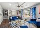 Stylish living room with large windows and hardwood floors and featuring bright blue, modern furniture and unique artwork at 3457 Scenic Dr, East Point, GA 30344