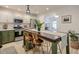 Well-lit kitchen with stainless steel appliances, white upper and green lower cabinets, and a center island at 690 Whitby Dr, Douglasville, GA 30134