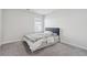 Neutral bedroom with plush carpet, natural light, and a modern headboard at 744 Clark Lake Estates Dr, Grayson, GA 30017