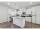Bright kitchen features stainless steel appliances, granite counters, a central island, and wood flooring at 744 Clark Lake Estates Dr, Grayson, GA 30017