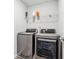 Convenient laundry room with modern washer and dryer units and overhead storage shelf at 744 Clark Lake Estates Dr, Grayson, GA 30017