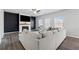 Comfortable living room with a fireplace, large sofa, and bright windows at 744 Clark Lake Estates Dr, Grayson, GA 30017