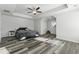 Spacious main bedroom boasts a tray ceiling, ceiling fan, ample natural light and hardwood floors at 744 Clark Lake Estates Dr, Grayson, GA 30017