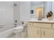 Bright white bathroom features a tiled shower and tub and a white vanity at 175 Lagrange Ct, Fayetteville, GA 30214