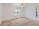 Bright bedroom featuring neutral walls, carpet, a ceiling fan, and a sun-filled window at 175 Lagrange Ct, Fayetteville, GA 30214