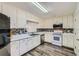 Bright kitchen with stainless steel appliances, white cabinetry, and mosaic backsplash at 175 Lagrange Ct, Fayetteville, GA 30214