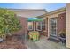 Brick patio with an umbrella-covered table and two chairs near rear entry at 175 Lagrange Ct, Fayetteville, GA 30214