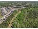 Discover this aerial view of a serene neighborhood bordering a lush green wooded area, ideal for nature lovers at 2031 Broadmoor Way, Fairburn, GA 30213