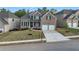 Beautiful brick home showcasing an attached two-car garage, landscaping, and a well-manicured lawn at 2031 Broadmoor Way, Fairburn, GA 30213
