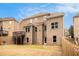 Back exterior showcasing a brick home with deck and covered patio, overlooking a lawn and backyard at 2031 Broadmoor Way, Fairburn, GA 30213