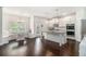 Open-concept kitchen featuring stainless steel appliances and a dining area at 2031 Broadmoor Way, Fairburn, GA 30213