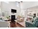 Bright living room with a cozy fireplace, soaring ceilings, and dark hardwood floors at 2031 Broadmoor Way, Fairburn, GA 30213