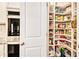 Walk-in pantry with custom shelving; kitchen has stainless double ovens at 2031 Broadmoor Way, Fairburn, GA 30213