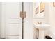 Charming powder room with a pedestal sink, decorative mirror, and fresh white paint at 2031 Broadmoor Way, Fairburn, GA 30213
