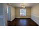 Dining room with chair rail, wood floors, and large window at 545 Woodrow Dr, Lawrenceville, GA 30043