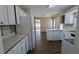 Bright kitchen with white cabinets, mosaic backsplash, and ample counter space at 545 Woodrow Dr, Lawrenceville, GA 30043