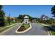 Scenic view of the community entrance, featuring manicured lawns and mature trees at 1311 Lakeside Overlook, Canton, GA 30114