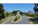 Scenic view of the community entrance, featuring manicured lawns and mature trees at 1311 Lakeside Overlook, Canton, GA 30114