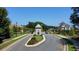 Scenic view of the community entrance, featuring manicured lawns and mature trees at 1311 Lakeside Overlook, Canton, GA 30114