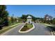 Scenic view of the community entrance, featuring manicured lawns and mature trees at 1311 Lakeside Overlook, Canton, GA 30114