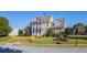 Charming home exterior with a columned porch, landscaped yard, and sidewalk at 1311 Lakeside Overlook, Canton, GA 30114