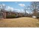 A spacious backyard with a brick home, privacy fence, and storage shed at 3831 Montford Dr, Atlanta, GA 30341