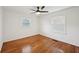 A bedroom with hardwood floors, two windows, and neutral paint at 3831 Montford Dr, Atlanta, GA 30341