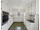 Vintage kitchen featuring green tile flooring, white cabinetry, and ample counter space at 3831 Montford Dr, Atlanta, GA 30341