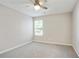 Cozy bedroom with a ceiling fan, carpet, and a large window at 455 Registry Blf, Stone Mountain, GA 30087