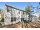 A full shot of the house with the backyard patio and a treelined scenery in the distance at 455 Registry Blf, Stone Mountain, GA 30087