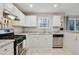 Bright kitchen featuring white cabinets, tile flooring, and modern appliances at 455 Registry Blf, Stone Mountain, GA 30087