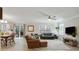 Spacious living room with light-colored floors, a ceiling fan, and abundant natural light at 455 Registry Blf, Stone Mountain, GA 30087