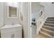 Convenient powder room featuring a white vanity next to the stairway at 455 Registry Blf, Stone Mountain, GA 30087