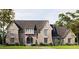 Stunning new traditional home with a brick facade, arched entry, and professionally landscaped lawn at 133 Laurel Brook Ln, Canton, GA 30115
