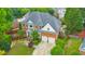 A stunning aerial view highlights a brick home with a lush backyard, pool, and well-maintained landscaping at 1250 Rosette Way, Marietta, GA 30062