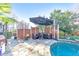 Outdoor patio with an umbrella, seating area, and partial view of the backyard pool at 1250 Rosette Way, Marietta, GA 30062