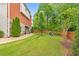 Manicured backyard with green lawn and stone and brick accents that create an inviting outdoor space at 1250 Rosette Way, Marietta, GA 30062