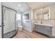 Contemporary bathroom with glass enclosed shower, gray vanity, and light blue walls at 1250 Rosette Way, Marietta, GA 30062