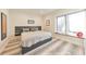 Comfortable bedroom with a modern platform bed, hardwood floors, and natural light from the window at 1250 Rosette Way, Marietta, GA 30062