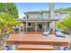 Large outdoor deck with lounge seating, a barbecue grill, and steps down to the landscaped backyard at 1250 Rosette Way, Marietta, GA 30062