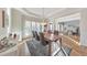 Well-lit dining room with hardwood floors, modern lighting, and views into the living area at 1250 Rosette Way, Marietta, GA 30062
