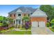 An impressive brick home with a manicured front yard, stone accents, and a spacious driveway at 1250 Rosette Way, Marietta, GA 30062